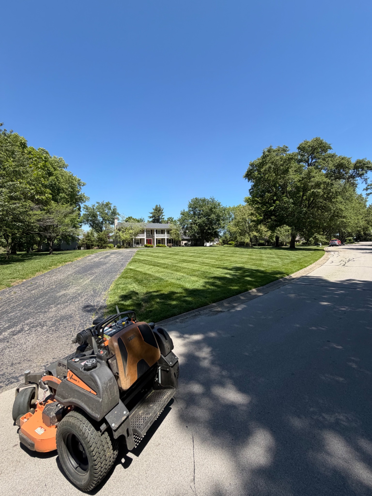 Zero-turn mower on a well-maintained residential lawn